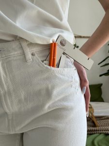 A Person in White Clothing with Drawing Instruments in a Pocket