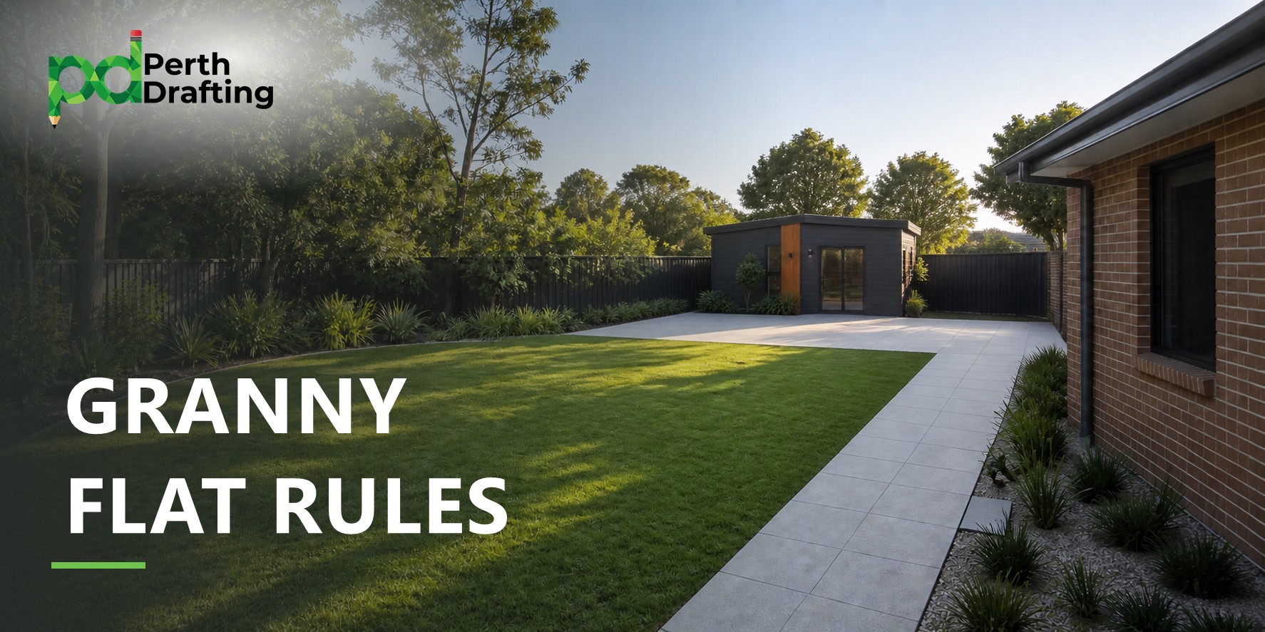 A well-kept backyard with a vibrant green lawn and a light grey paved pathway leading past a brick house towards the back. In the rear corner of the yard sits a modern, charcoal-grey granny flat with timber accents and glass sliding doors, framed by boundary fencing and leafy green trees.